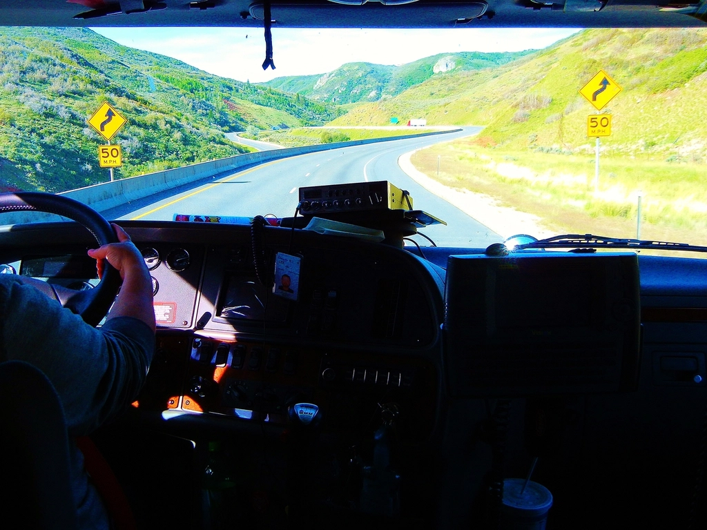 Juan J. Rebollo, owner-operator of Rebollo Haul, beside his truck cab on Okeechobee ranch land
